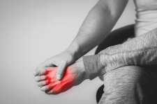 119842439-causian-man-holds-hands-to-his-painful-feet-pain-in-foot-black-and-white-photography...jpg